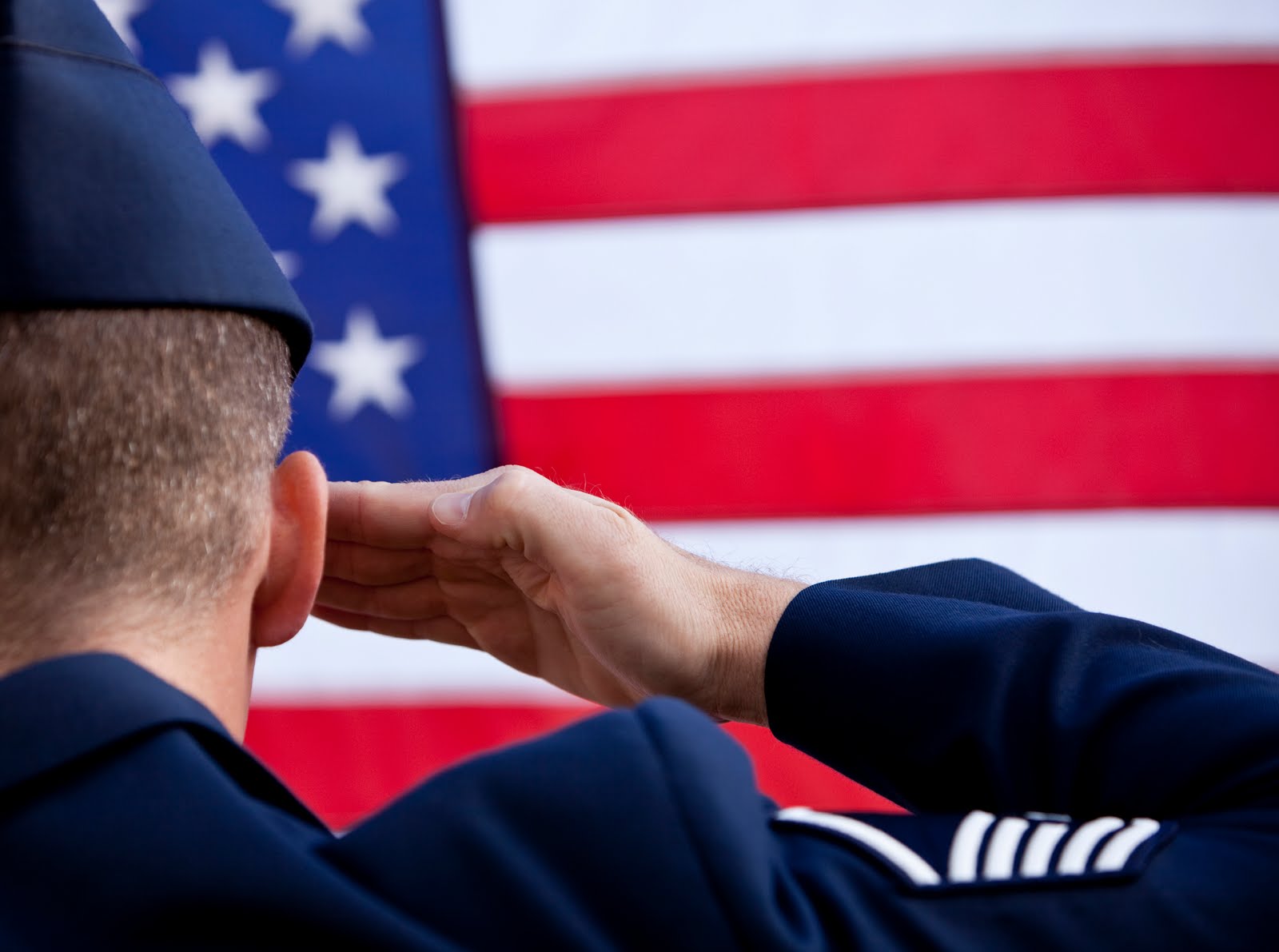 A photo of an Air Force member saluting the American flag