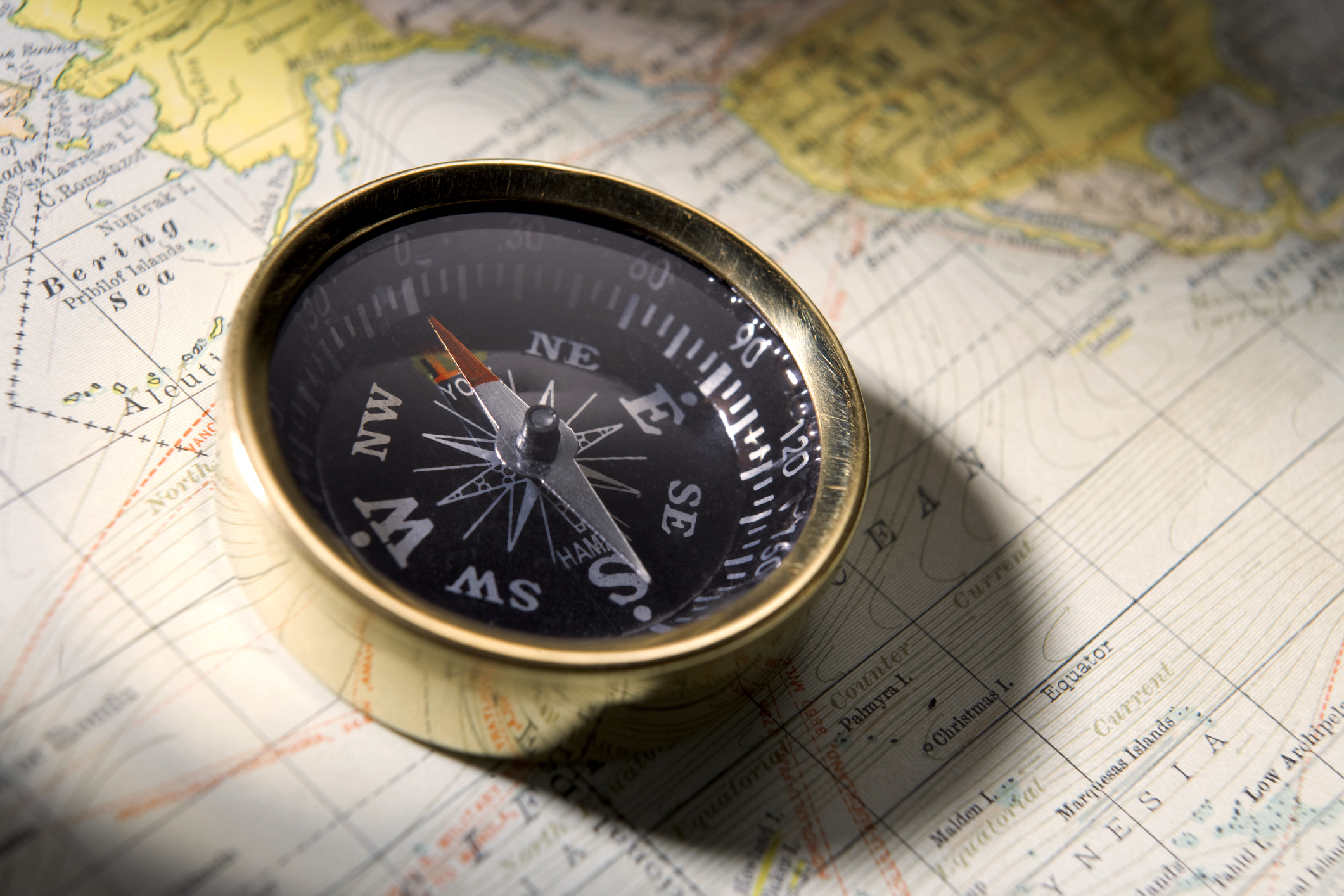 A compass sitting on a map